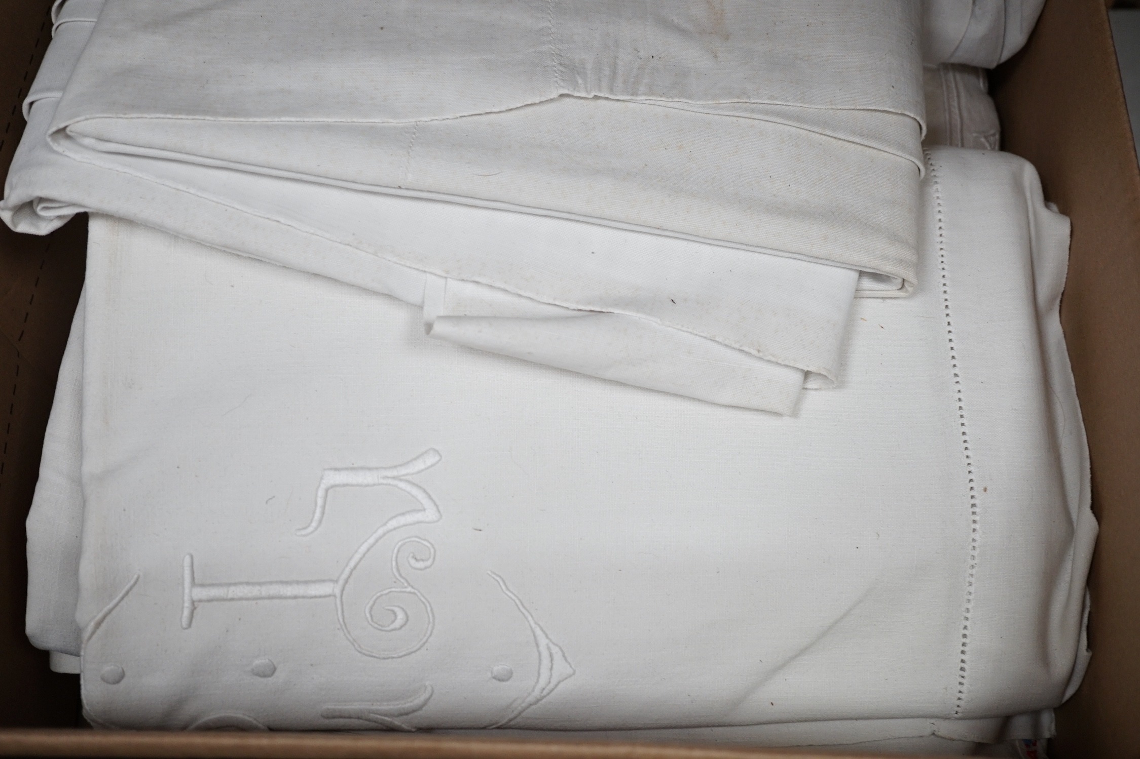 Twelve coarse woven, mostly monogrammed sheets